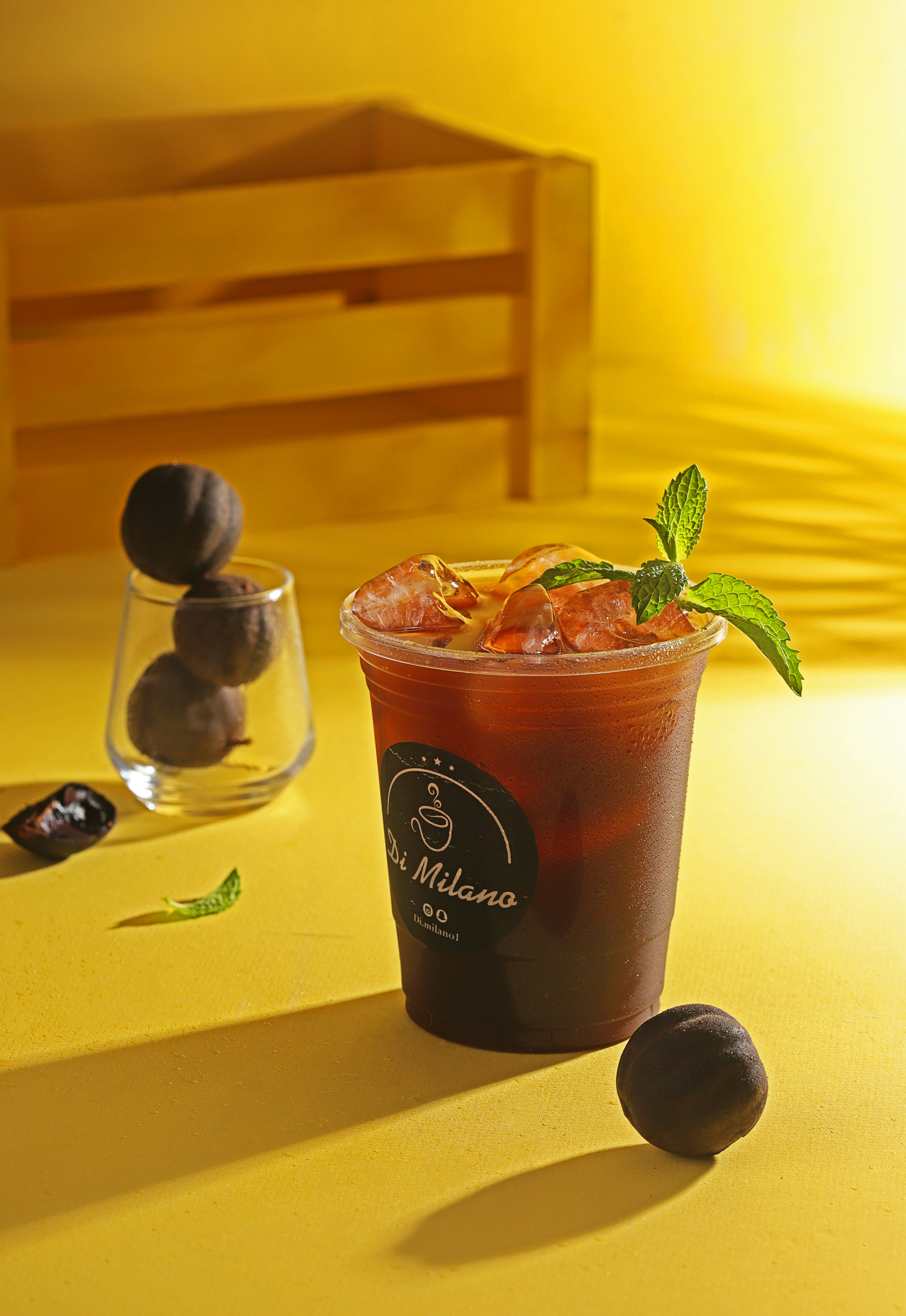 black and brown plastic cup with green plant